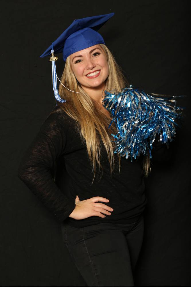 blonde student in grad cap with pom pom